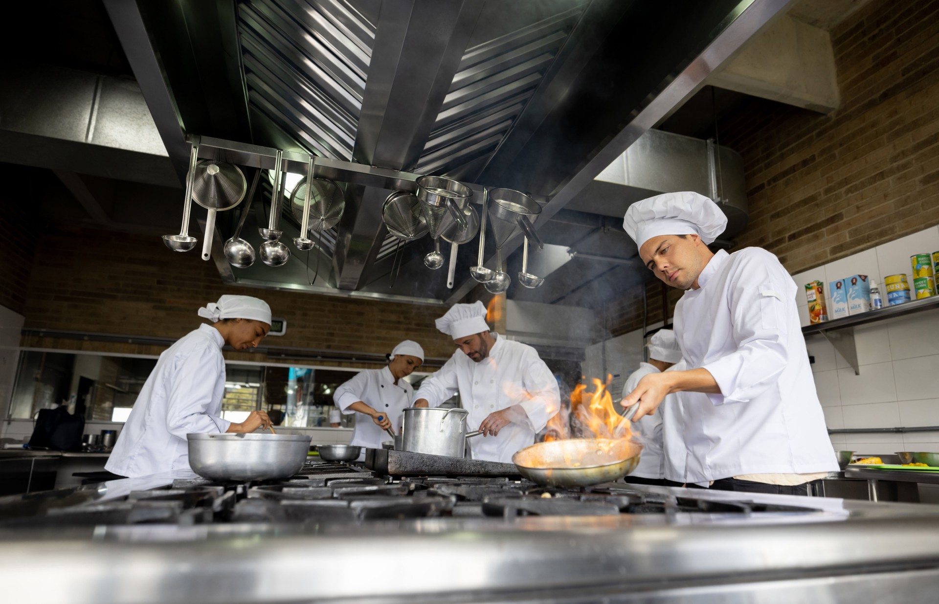 Group of chefs cooking in the kitchen of a restaurant